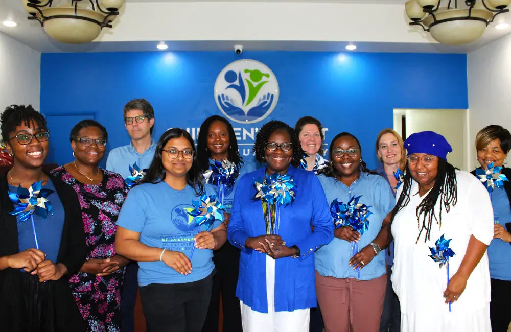Children's Trust staff holding blue pinwheels during child abuse prevention awareness event